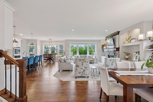 62 Rapp Farm Blvd, North Oaks, MN 55127 - dining space with wood finished floors, a stone fireplace, and recessed lighting