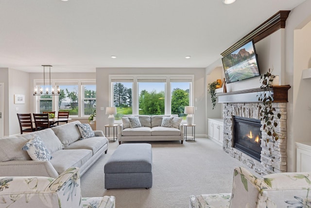 62 Rapp Farm Blvd, North Oaks, MN 55127 - living room with a stone fireplace, plenty of natural light, light carpet, recessed lighting, and baseboards