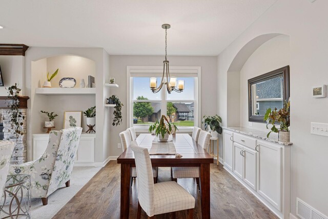 62 Rapp Farm Blvd, North Oaks, MN 55127 - dining space with a chandelier, light wood-style flooring, and built in features
