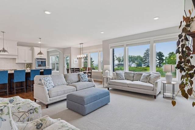 62 Rapp Farm Blvd, North Oaks, MN 55127 - living room featuring arched walkways, recessed lighting, and a chandelier