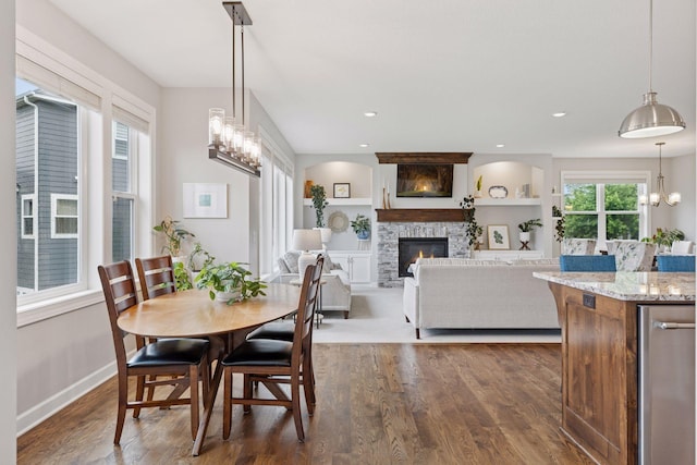 62 Rapp Farm Blvd, North Oaks, MN 55127 - dining room with a fireplace, dark wood finished floors, a chandelier, baseboards, and built in features