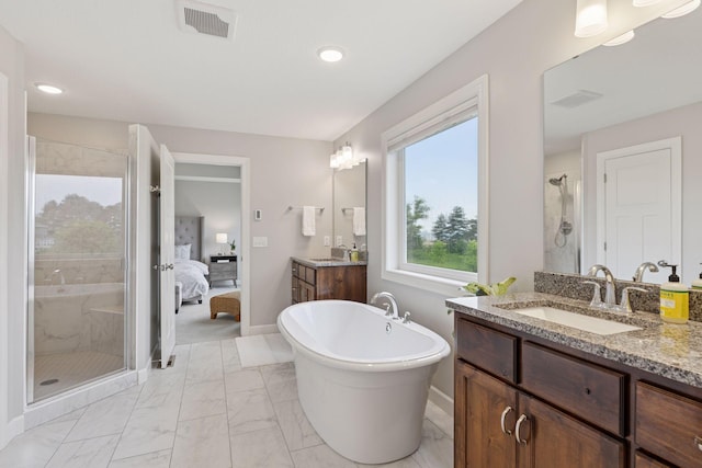 62 Rapp Farm Blvd, North Oaks, MN 55127 - ensuite bathroom featuring a shower stall, marble finish flooring, two vanities, baseboards, and a freestanding bath