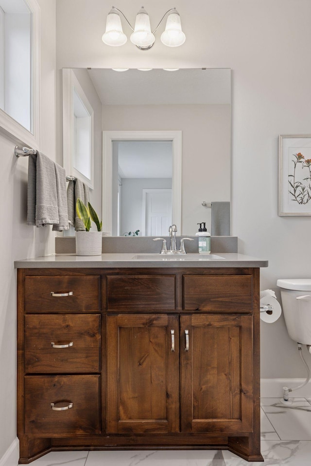 62 Rapp Farm Blvd, North Oaks, MN 55127 - bathroom featuring vanity, toilet, baseboards, and marble finish flooring