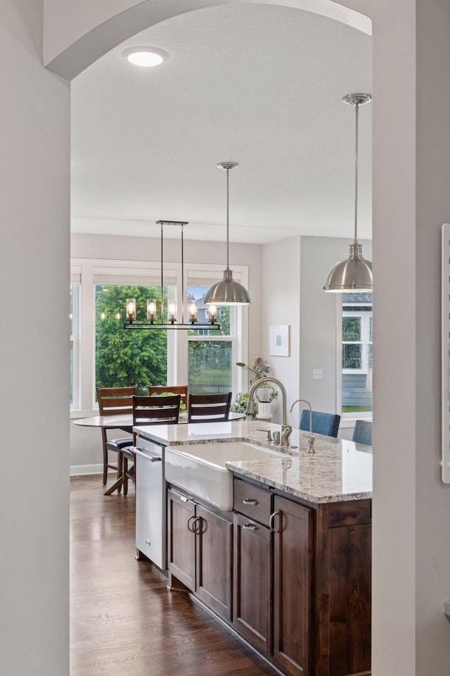 62 Rapp Farm Blvd, North Oaks, MN 55127 - kitchen with dishwasher, dark wood finished floors, dark brown cabinets, a center island with sink, and pendant lighting