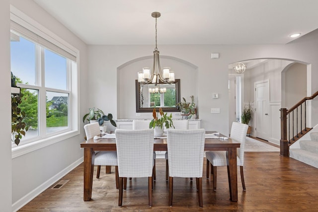 62 Rapp Farm Blvd, North Oaks, MN 55127 - dining room featuring a chandelier, stairs, dark wood-style flooring, and arched walkways