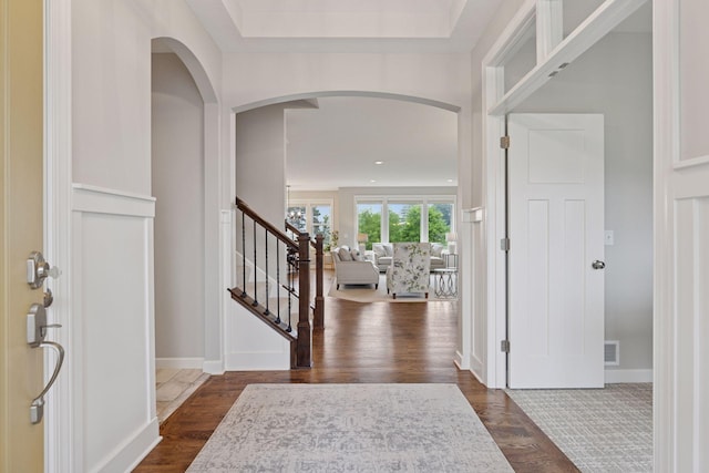 62 Rapp Farm Blvd, North Oaks, MN 55127 - entrance foyer with arched walkways, stairs, and dark wood-style flooring