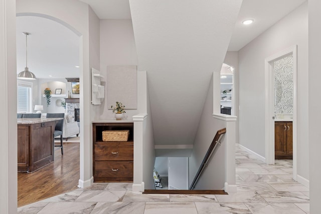62 Rapp Farm Blvd, North Oaks, MN 55127 - hallway with an upstairs landing, arched walkways, and light marble finish flooring