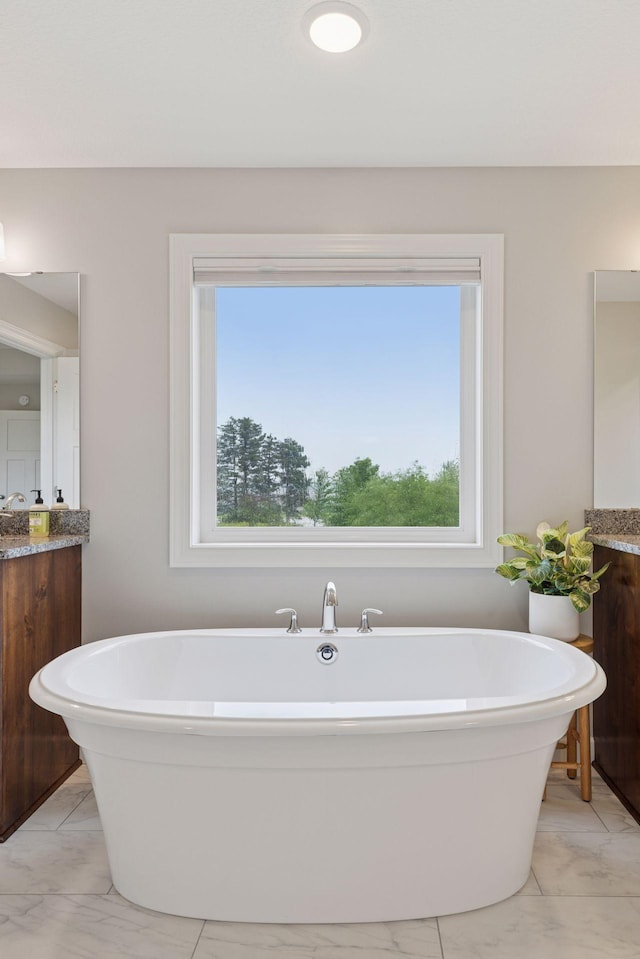 62 Rapp Farm Blvd, North Oaks, MN 55127 - full bathroom with vanity, a soaking tub, plenty of natural light, and marble look tiles