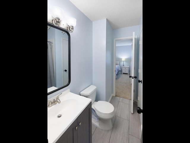 10308 Belmont Rd, Minnetonka, MN 55305 - full bathroom featuring vanity, toilet, and wood tiled floors