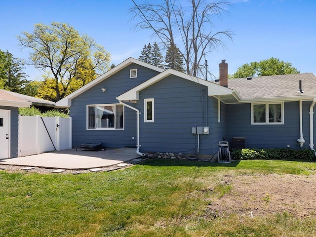 10308 Belmont Rd, Minnetonka, MN 55305 - rear view of property with a patio, a chimney, and a gate
