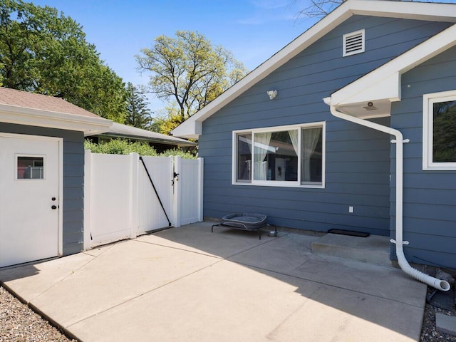 10308 Belmont Rd, Minnetonka, MN 55305 - view of side of property with a patio and a gate
