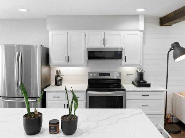 10308 Belmont Rd, Minnetonka, MN 55305 - kitchen with appliances with stainless steel finishes, white cabinets, tasteful backsplash, light stone counters, and recessed lighting