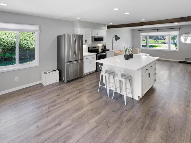 10308 Belmont Rd, Minnetonka, MN 55305 - kitchen with stainless steel appliances, white cabinets, dark wood finished floors, baseboards, and recessed lighting