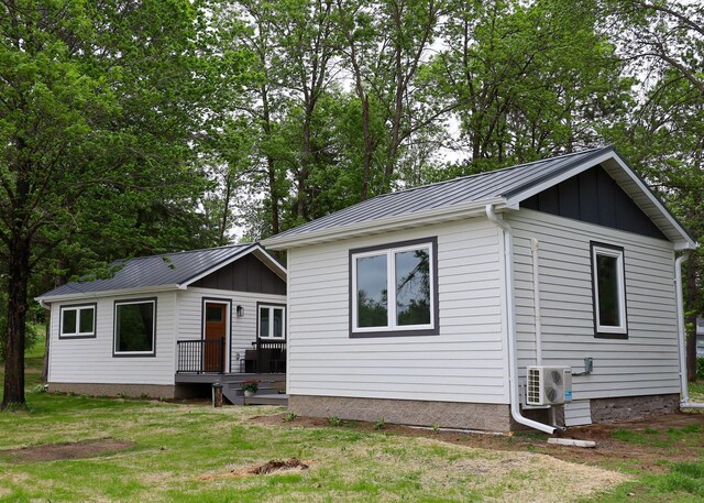 11445 State Highway 48, Trade Lake, WI 54853 - single story home with ac unit, metal roof, a front lawn, a standing seam roof, and board and batten siding