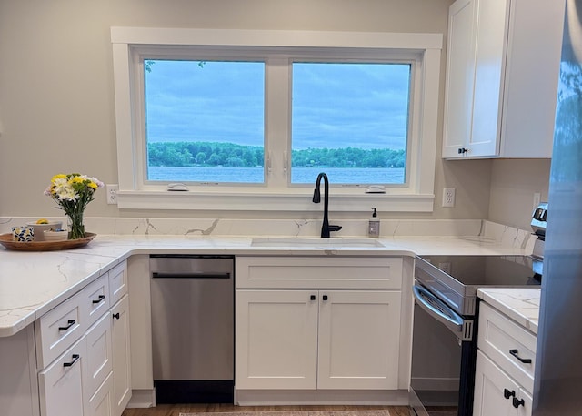 11445 State Highway 48, Trade Lake, WI 54853 - kitchen featuring appliances with stainless steel finishes, a sink, white cabinets, and plenty of natural light