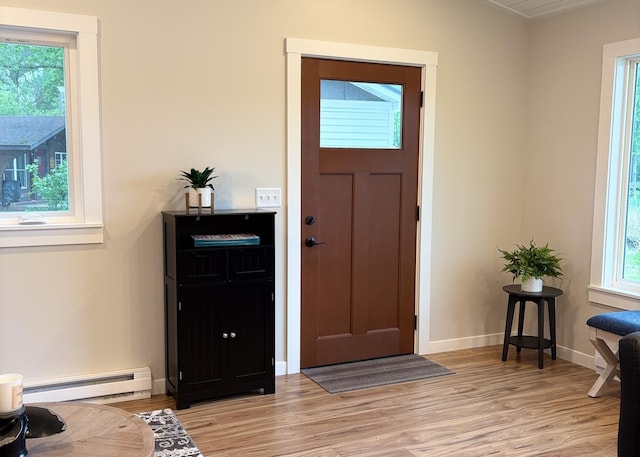 11445 State Highway 48, Trade Lake, WI 54853 - entrance foyer with baseboard heating, light wood-style flooring, baseboards, and ornamental molding