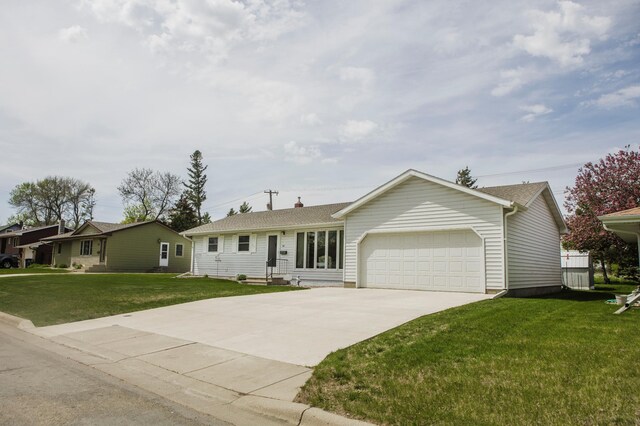 single story home with an attached garage, concrete driveway, and a front yard