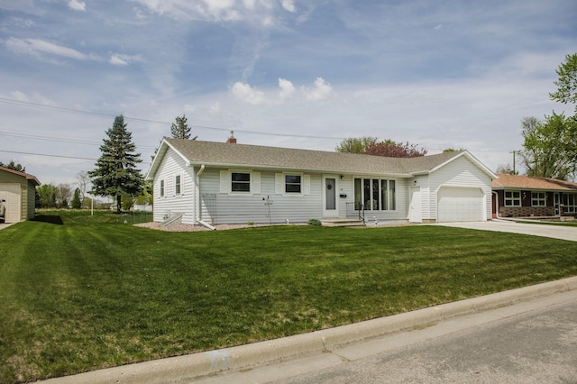 single story home featuring concrete driveway, a garage, a front lawn, and a chimney