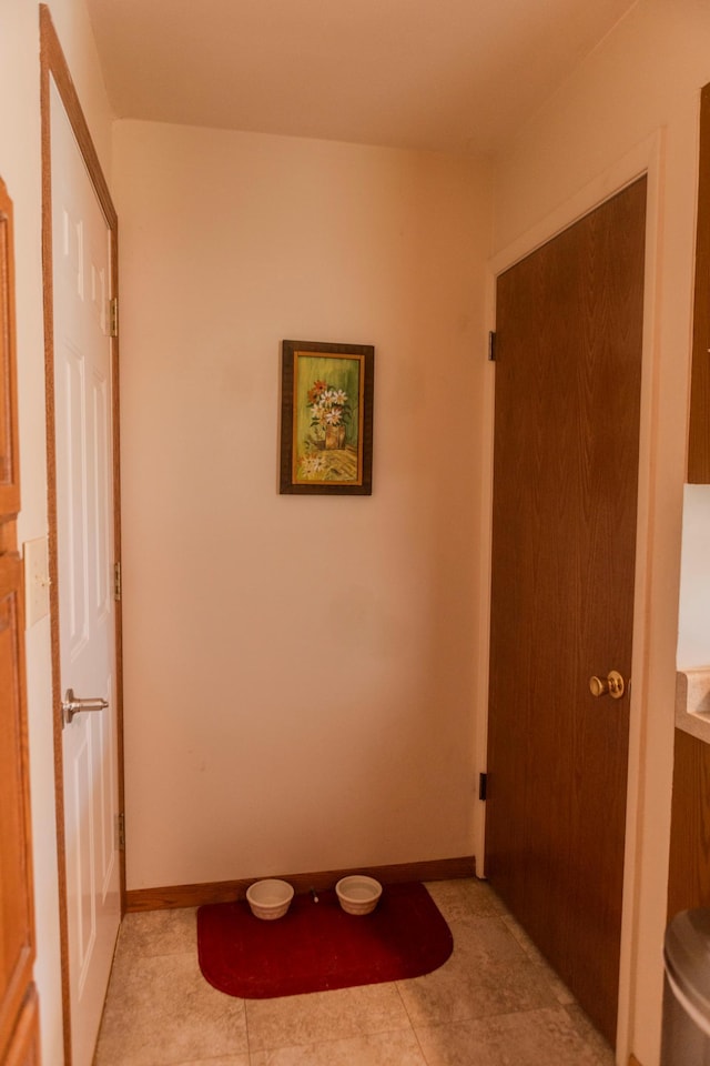 bathroom with tile patterned flooring and baseboards