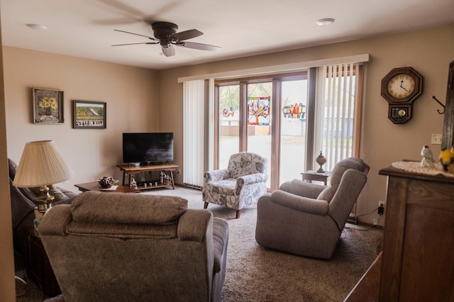 living area featuring a ceiling fan and carpet flooring