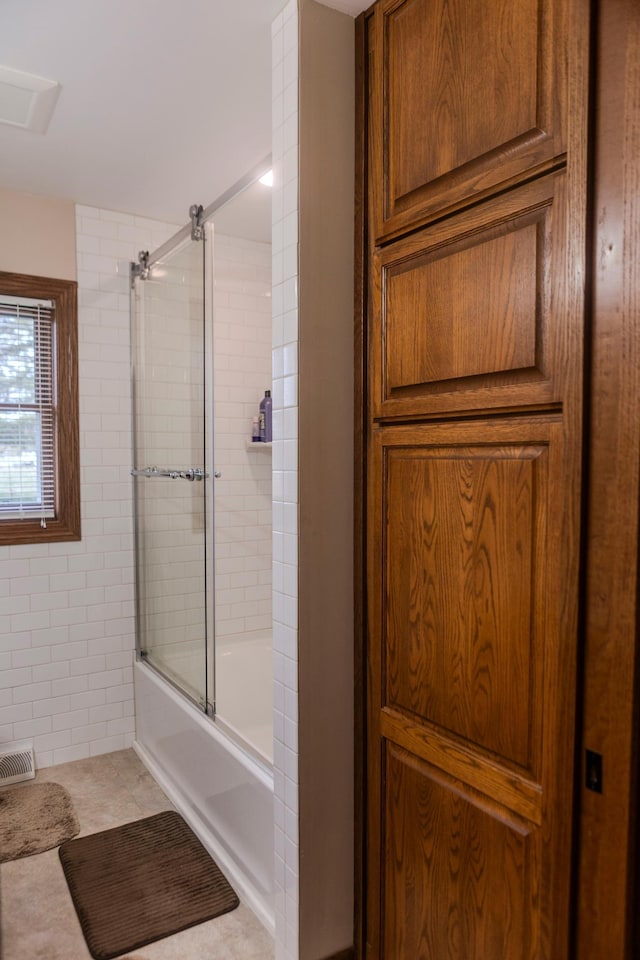 full bathroom with shower / bath combination with glass door and tile patterned floors