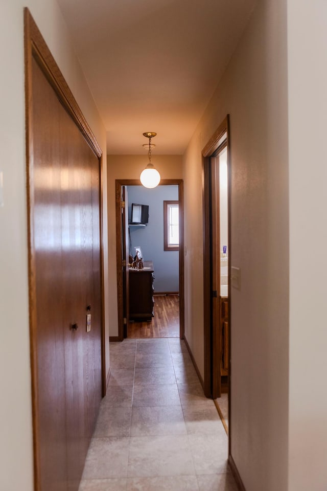 hall featuring baseboards