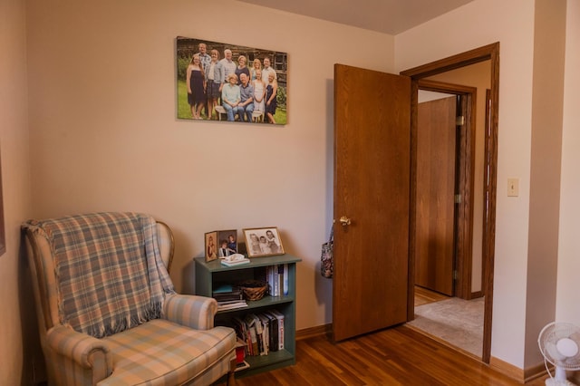 sitting room with wood finished floors and baseboards