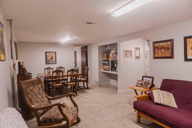 living room featuring light colored carpet and baseboards