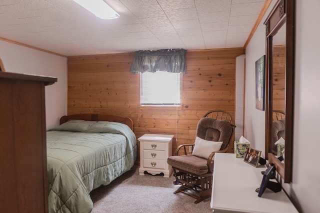 bedroom with wood walls, carpet, and ornamental molding