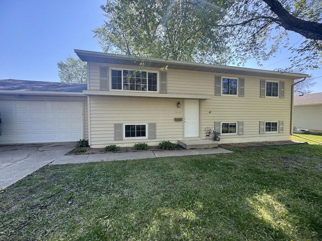 1601 8th Ave NE, Owatonna, MN 55060 - view of front of home with a front yard, an attached garage, and concrete driveway