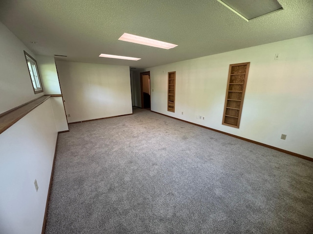 1601 8th Ave NE, Owatonna, MN 55060 - carpeted empty room featuring a textured ceiling and baseboards