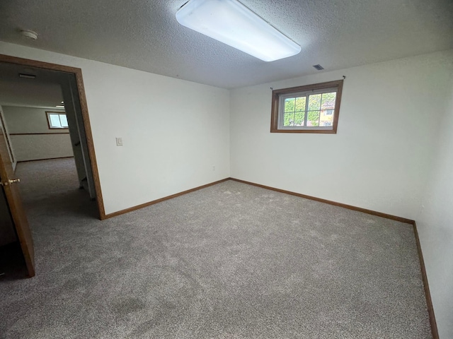 1601 8th Ave NE, Owatonna, MN 55060 - carpeted spare room with a textured ceiling, baseboards, and a smoke detector