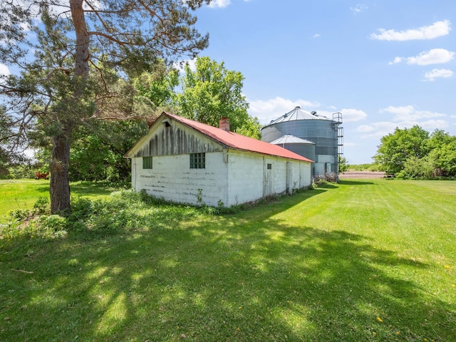 8418 State Highway 29 S, Alexandria, MN 56308 - view of property exterior with a yard, a chimney, concrete block siding, and metal roof