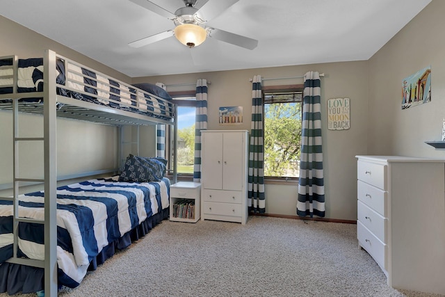bedroom with carpet floors, baseboards, and a ceiling fan