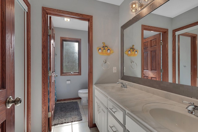 full bath featuring tile patterned flooring, toilet, double vanity, and baseboards