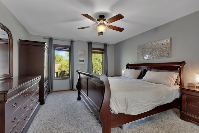 bedroom featuring light carpet, baseboards, and ceiling fan