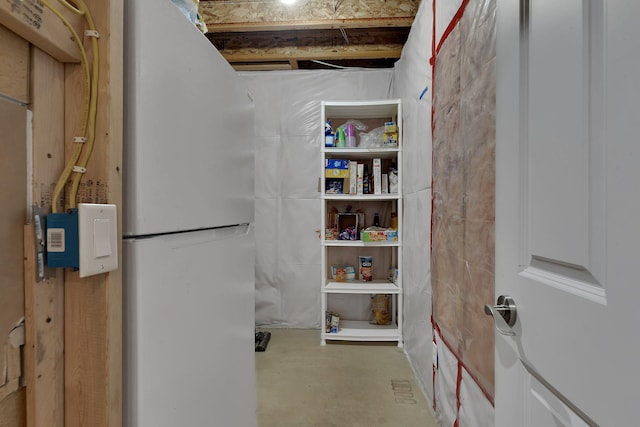basement featuring freestanding refrigerator