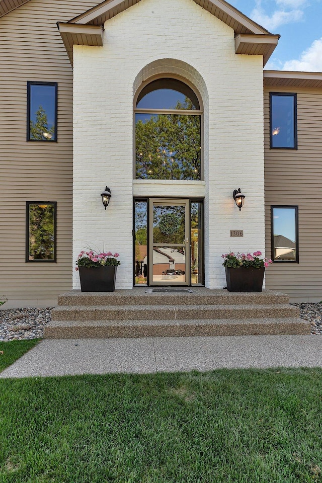 entrance to property with brick siding