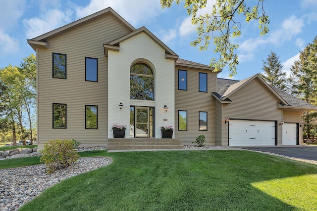 view of front facade with an attached garage, a front lawn, asphalt driveway, a shingled roof, and brick siding
