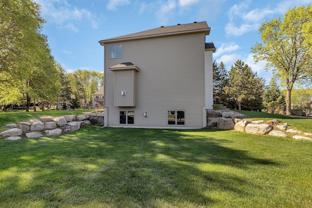 back of property featuring a yard