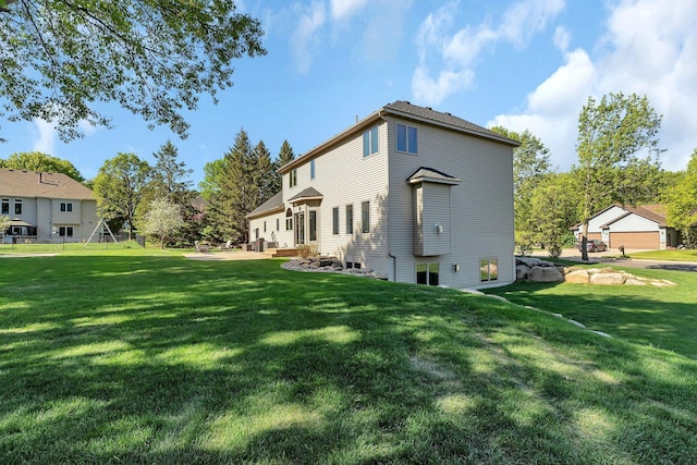 rear view of property with a yard