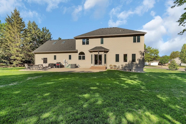 rear view of house with a patio area, a lawn, and entry steps