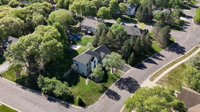 aerial view of property and surrounding area featuring nearby suburban area