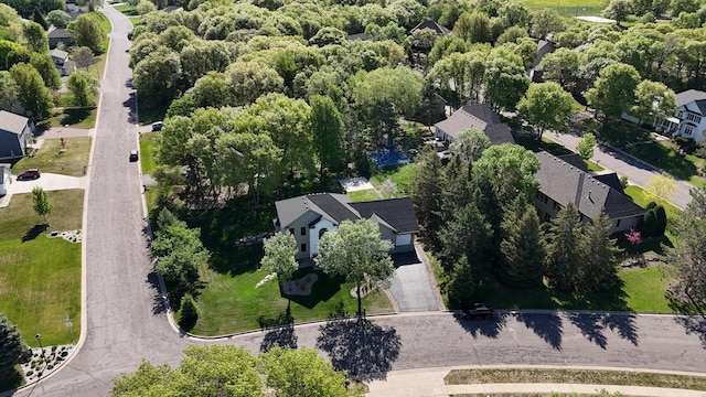 aerial view of property and surrounding area featuring nearby suburban area