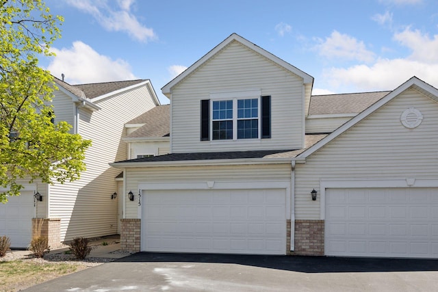 1515 Yorkshire Ln, Shakopee, MN 55379 - traditional-style house with a shingled roof, brick siding, and driveway
