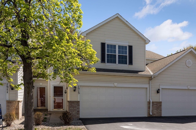 1515 Yorkshire Ln, Shakopee, MN 55379 - view of front of property with brick siding, roof with shingles, driveway, and a garage