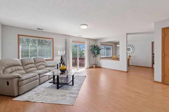 1515 Yorkshire Ln, Shakopee, MN 55379 - living room with a textured ceiling, wood finished floors, and baseboards