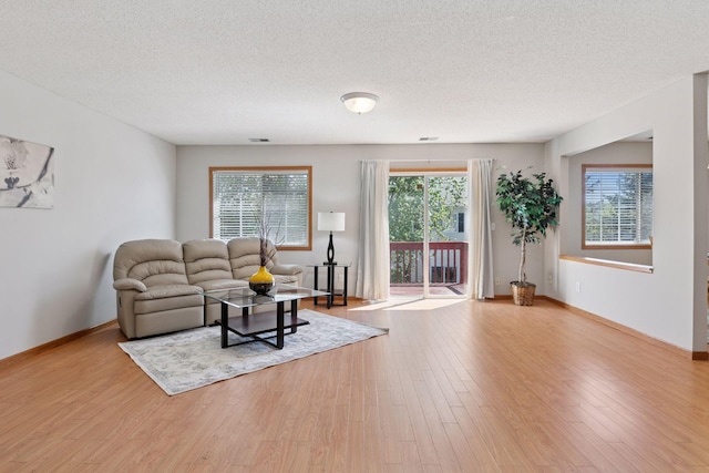 1515 Yorkshire Ln, Shakopee, MN 55379 - living area featuring wood finished floors, a textured ceiling, and baseboards