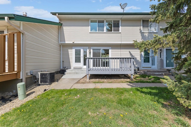 back of house featuring central AC unit, a yard, and a deck