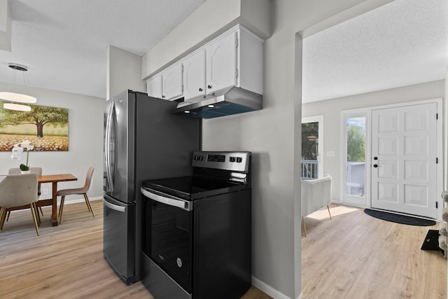 kitchen featuring range with electric stovetop, under cabinet range hood, white cabinets, a textured ceiling, and light wood-type flooring